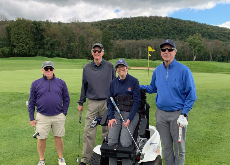 Push to Walk clients and event participants smiling on a green golf course