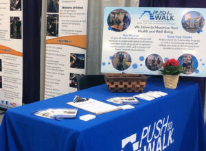 Push to Walk's booth display and blue tablecloth at the Abilities Expo 2022