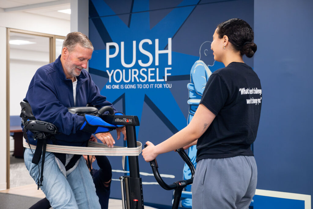 Push to Walk's Client being assisted by one of their high tech machines