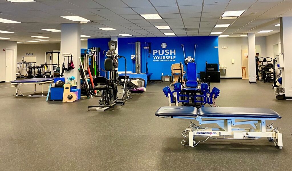 The state-of-the-art Push to Walk gym, with a bright wall decal that says "Push Yourself"